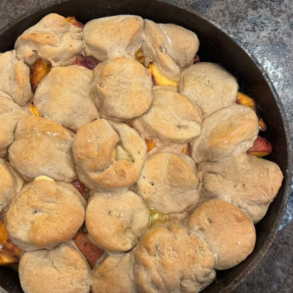 sourdough peach cobbler in cast iron
