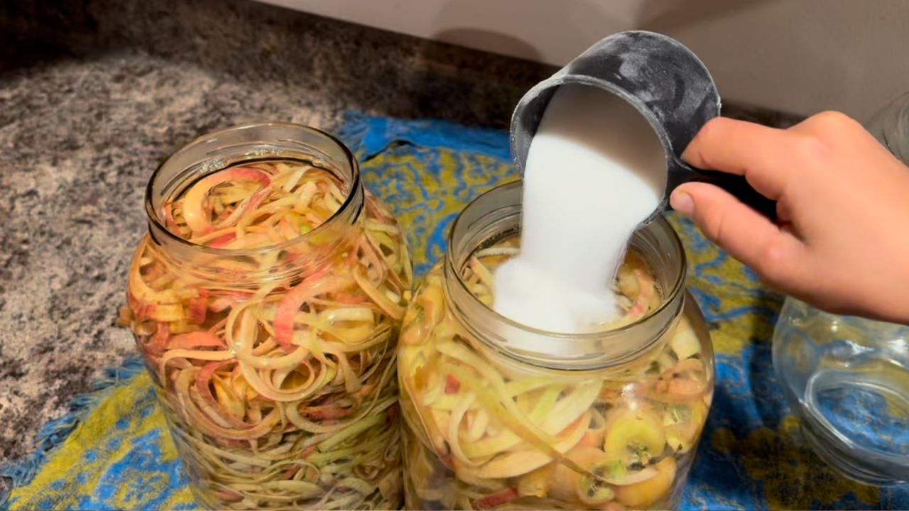 adding sugar to apple scraps for apple cider vinegar
