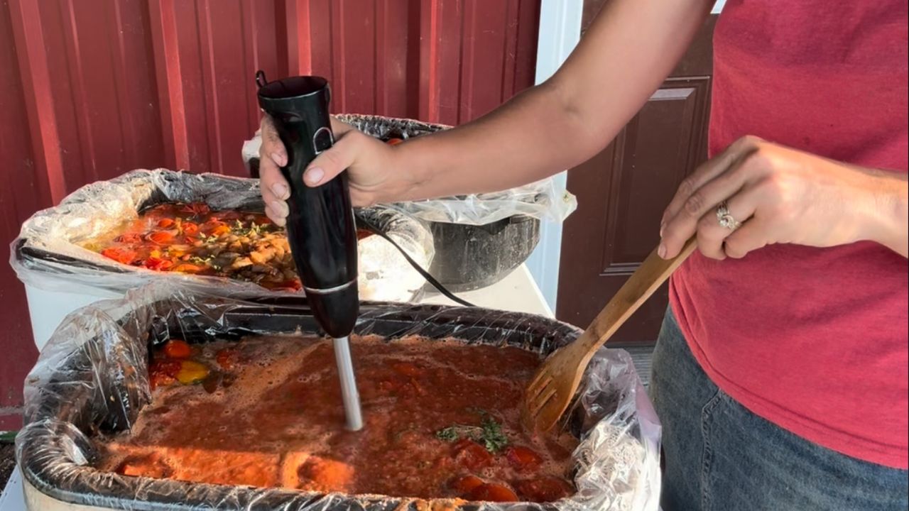 blending spices into homemade spaghetti sauce