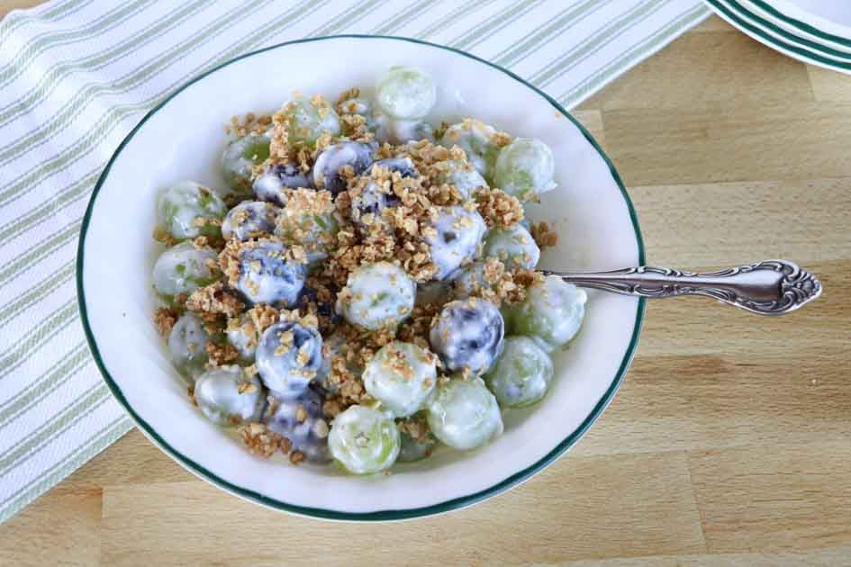 creamy grape salad with granola and spoon