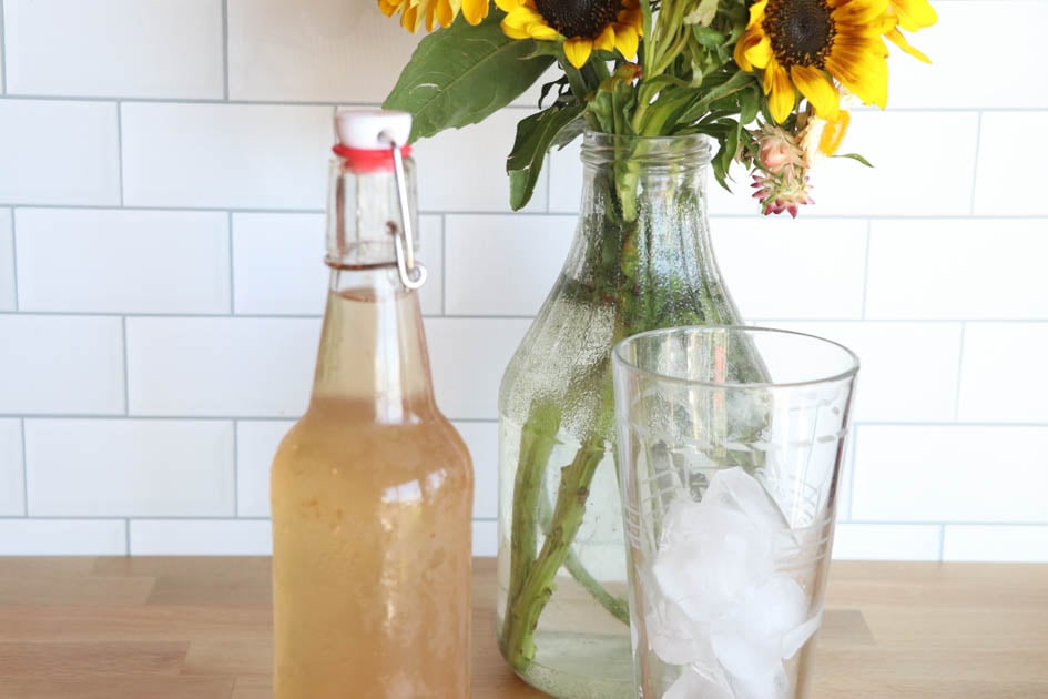 cold bottle of water kefir with glass of ice