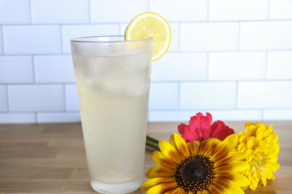 glass of fermented lemonade with flowers