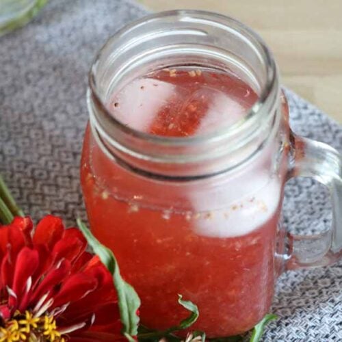 glass of gatorade on ice with flowers