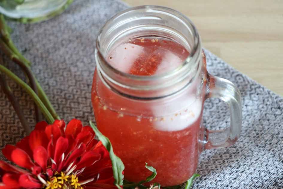glass of gatorade on ice with flowers