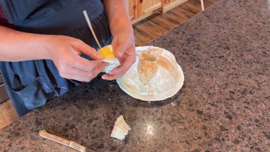 peeling paper off of butter candle