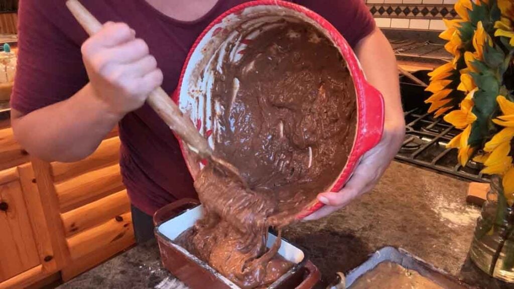 adding chocolate zucchini bread to pan