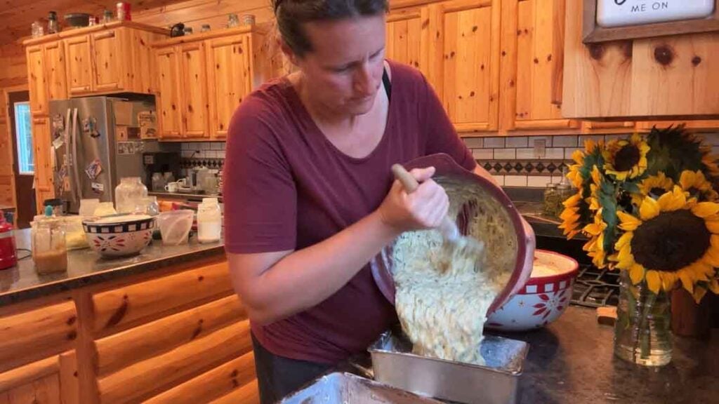 adding lemon poppyseed zucchini bread to pans