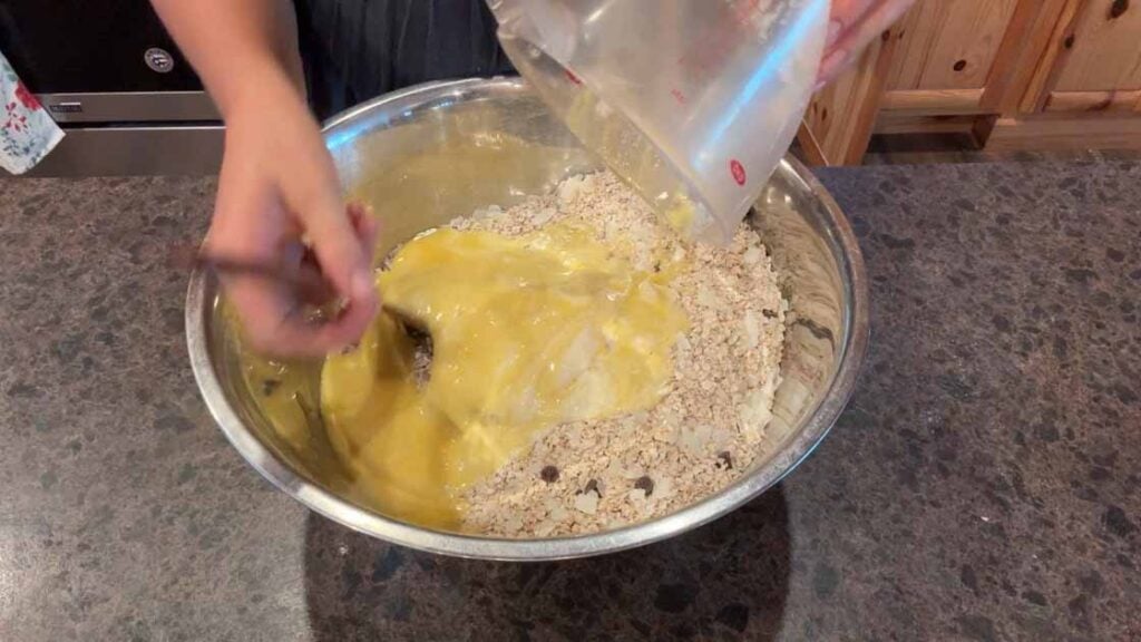 adding wet ingredients to sourdough granola