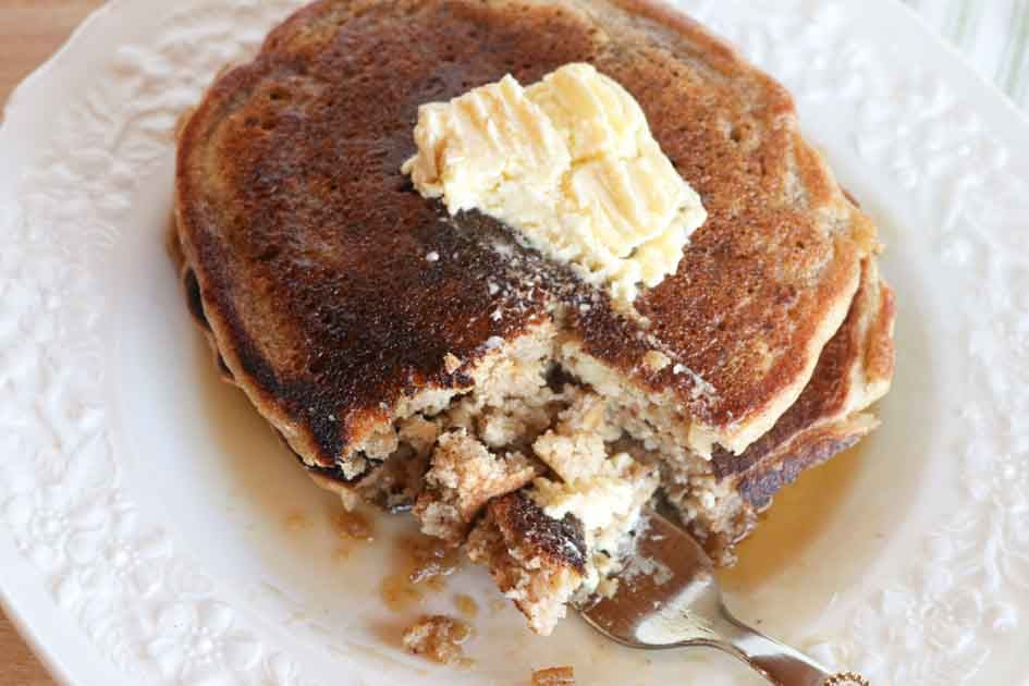 bite of pumpkin pancakes with fresh butter and maple syrup horizontal