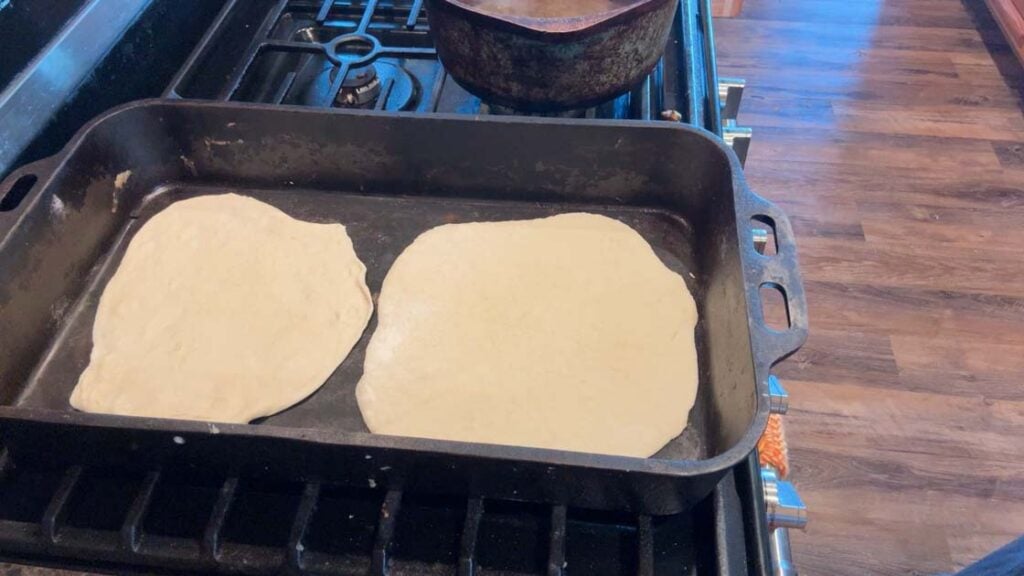 cast iron skillet with sourdough tortillas