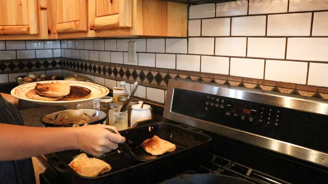 cooking pumpkin pancakes on a cast iron skillet