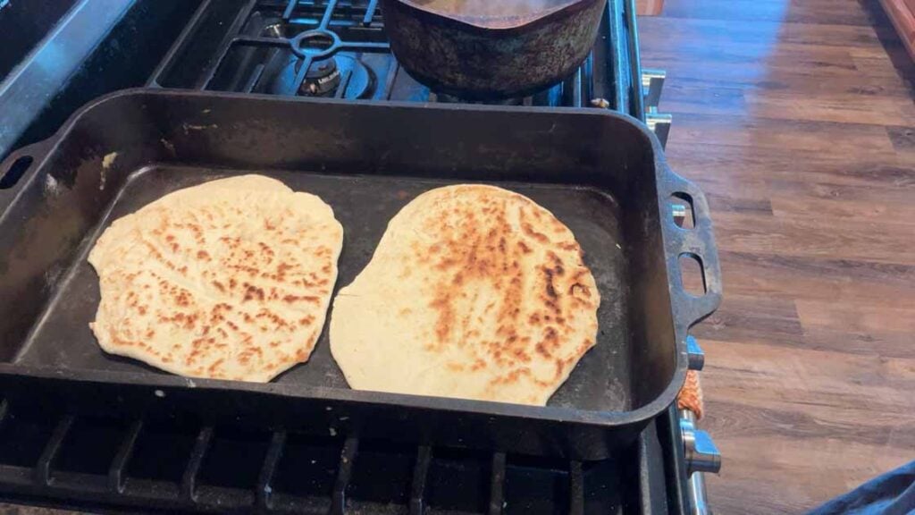 cooking sourdough tortillas in cast iron