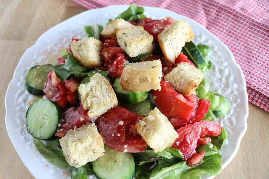 plate of salad with croutons by towel
