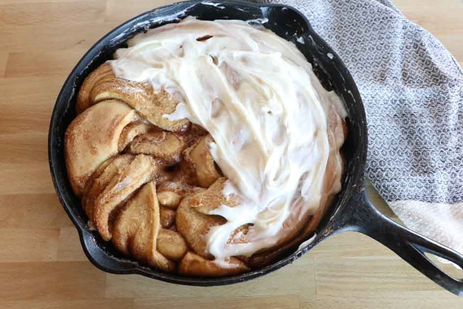 sourdough cinnamon twist with frosting in skillet