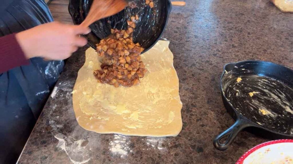 adding apple filling to cinnamon rolls