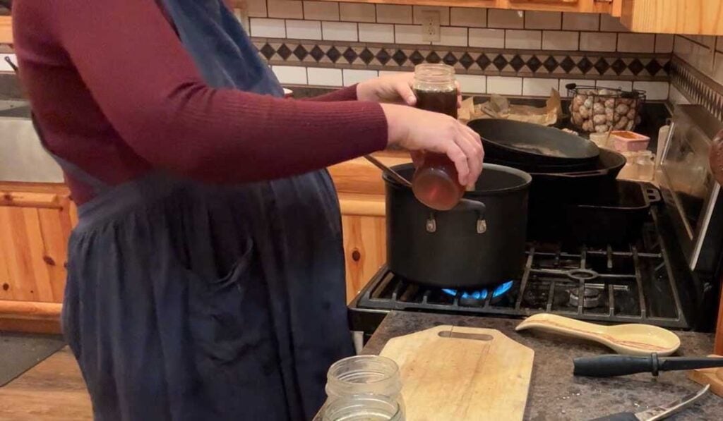 adding broth to cheeseburger soup