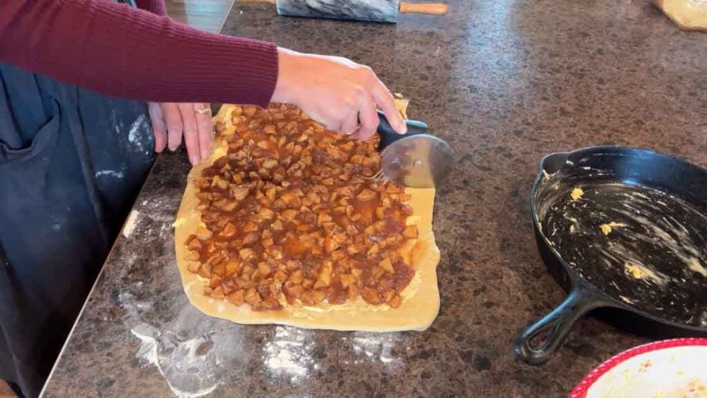 cutting caramel apple cinnamon rolls