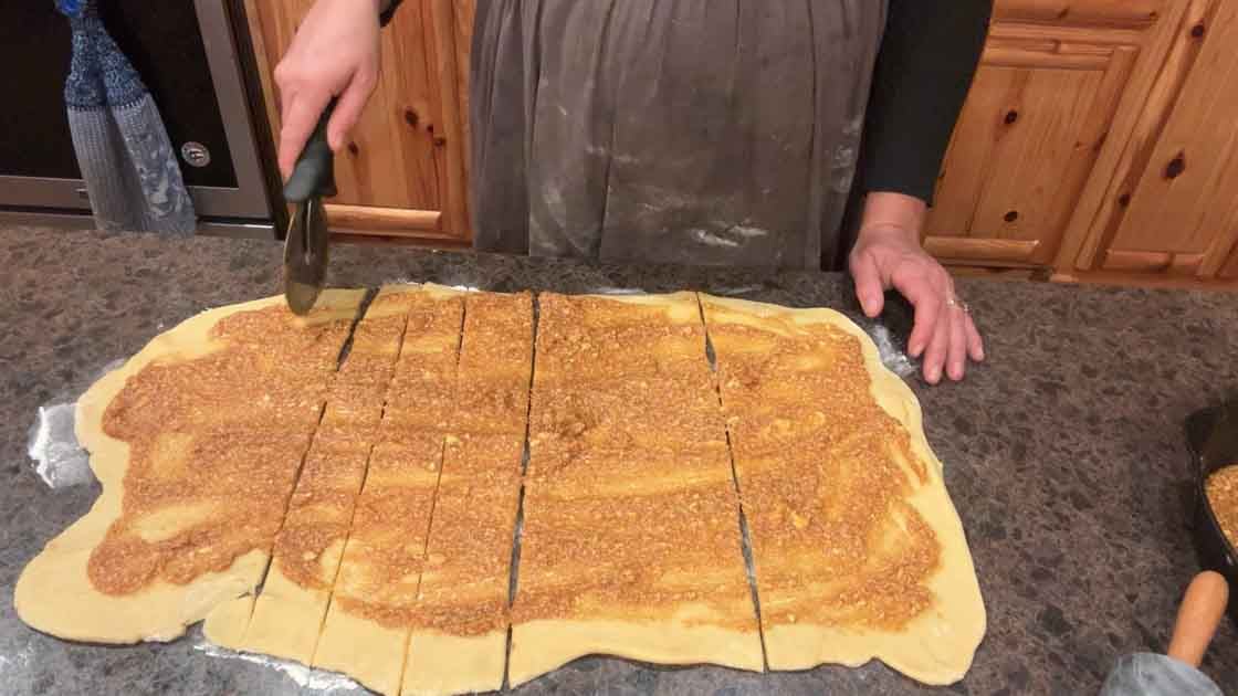 cutting pumpkin cinnamon rolls