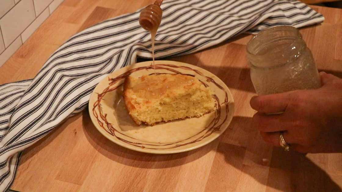 drizzling honey over sourdough cornbread
