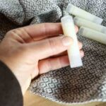 lady holding tallow lip balm