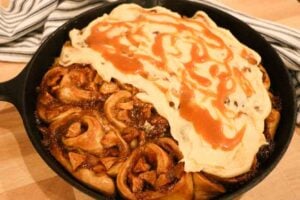 partially frosted caramel apple cinnamon rolls up close