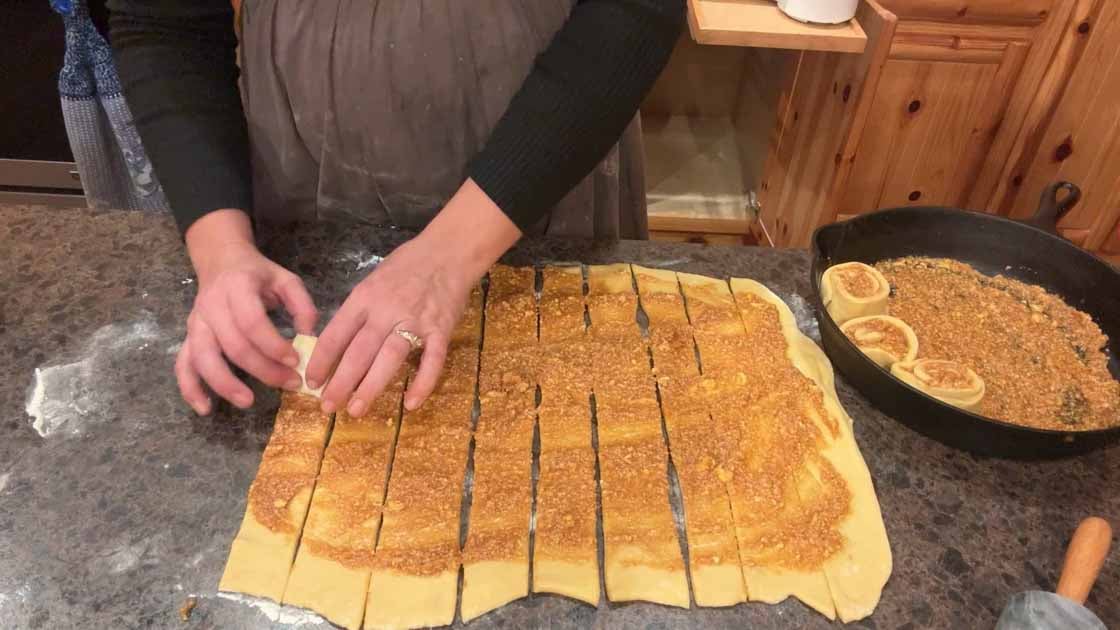 rolling up sourdough pumpkin cinnamon rolls