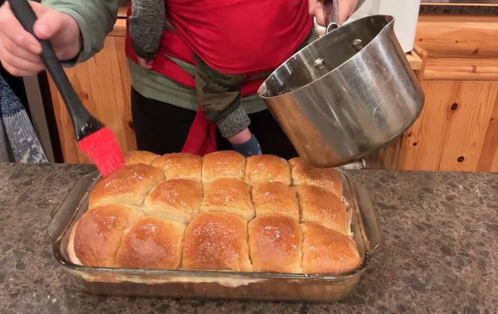 drizzling butter glaze over sliders