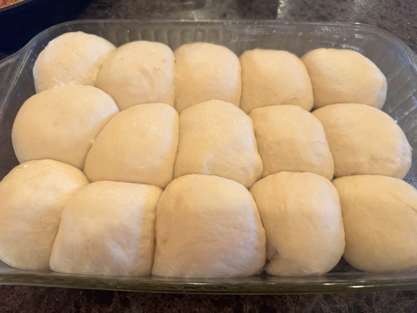 pan of risen sourdough hawaiian rolls