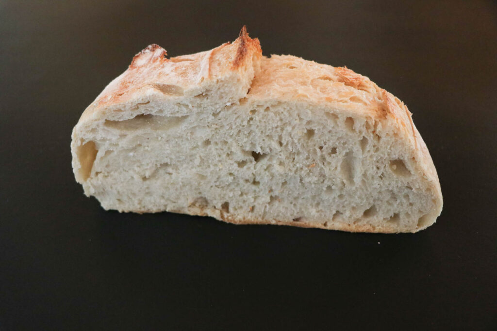 cut artisan sourdough bread on black