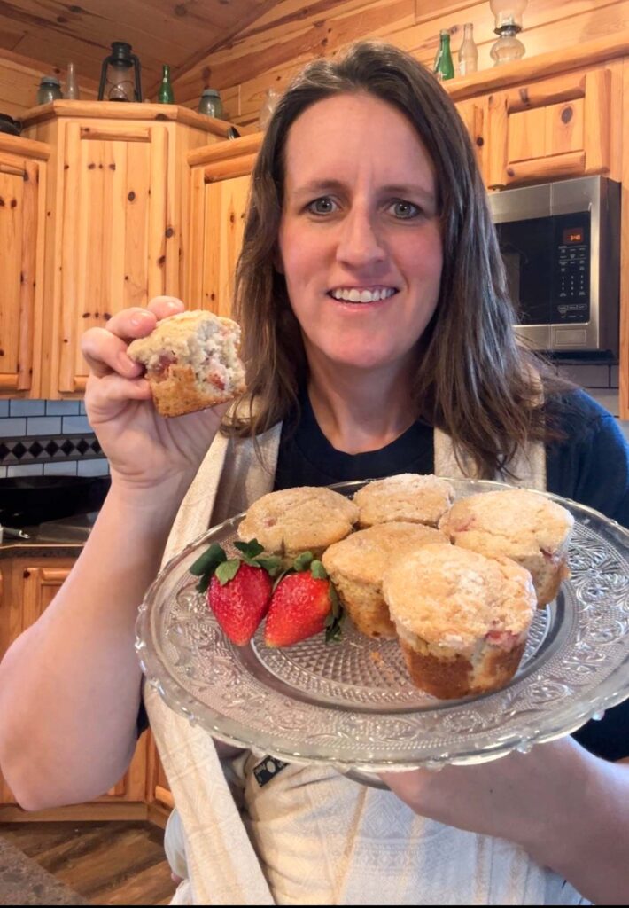 lady holding sourdough strawberry muffins