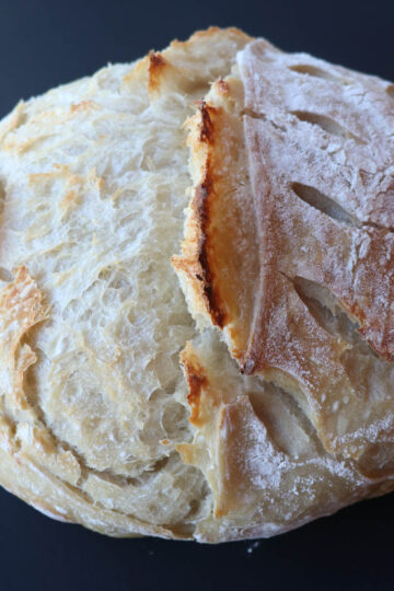 loaf of artisan sourdough bread on black square