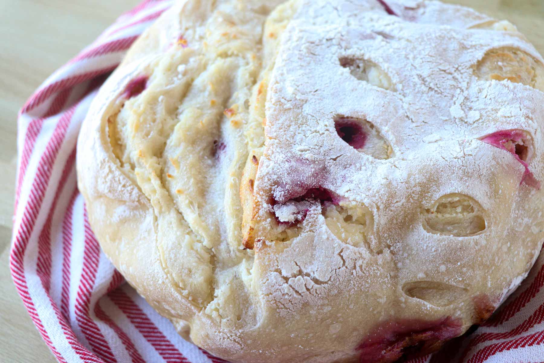 raspberry cheesecake sourdough bread with towel