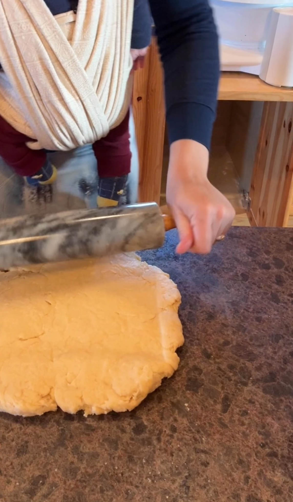 rolling out orange cinnamon roll dough.