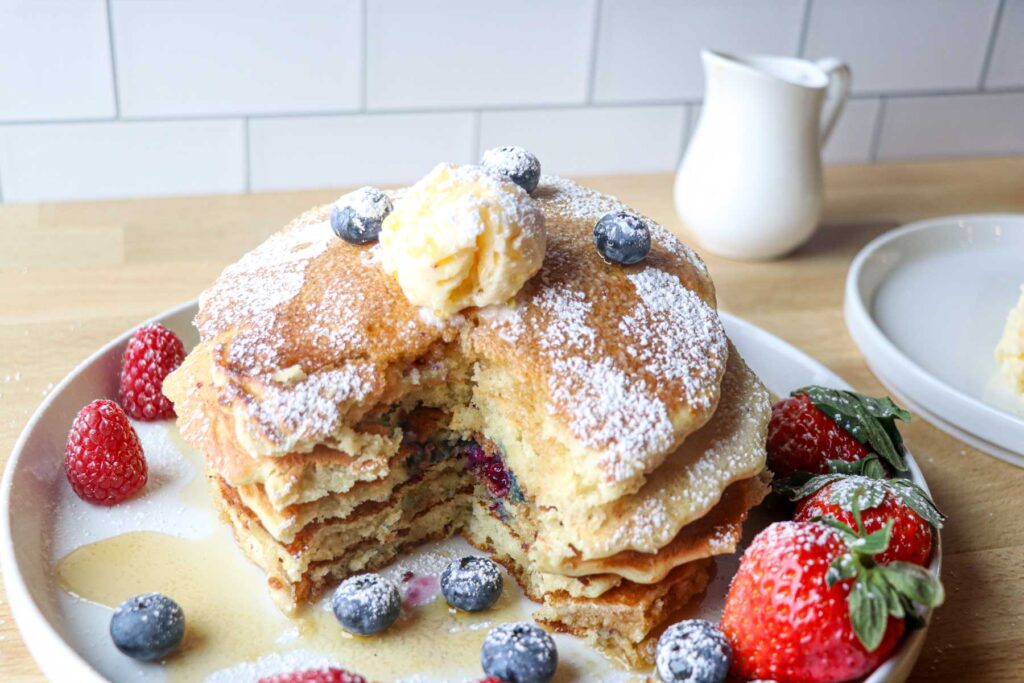 sourdough blueberry pancakes on a plate with berries