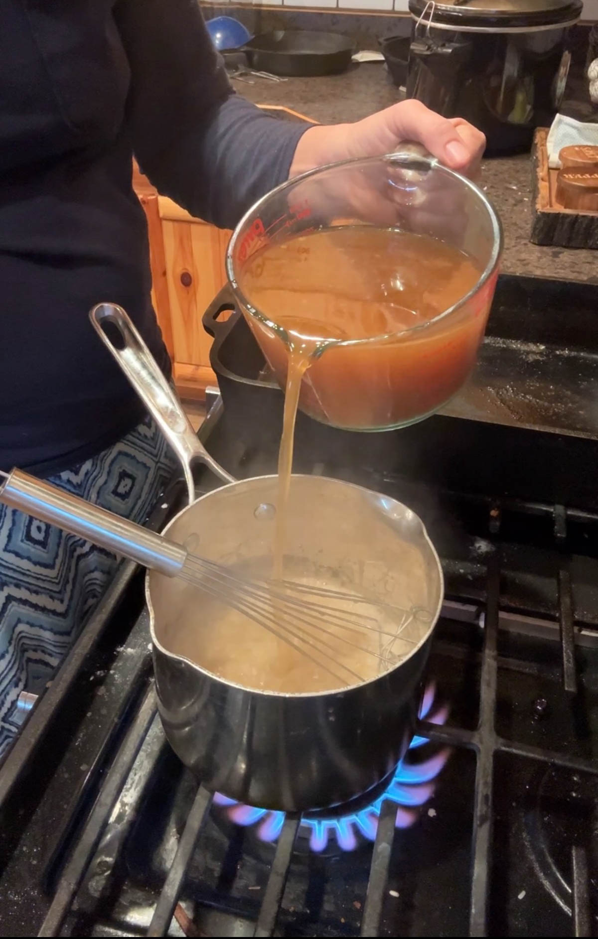 pouring meat juices into pan for brown gravy