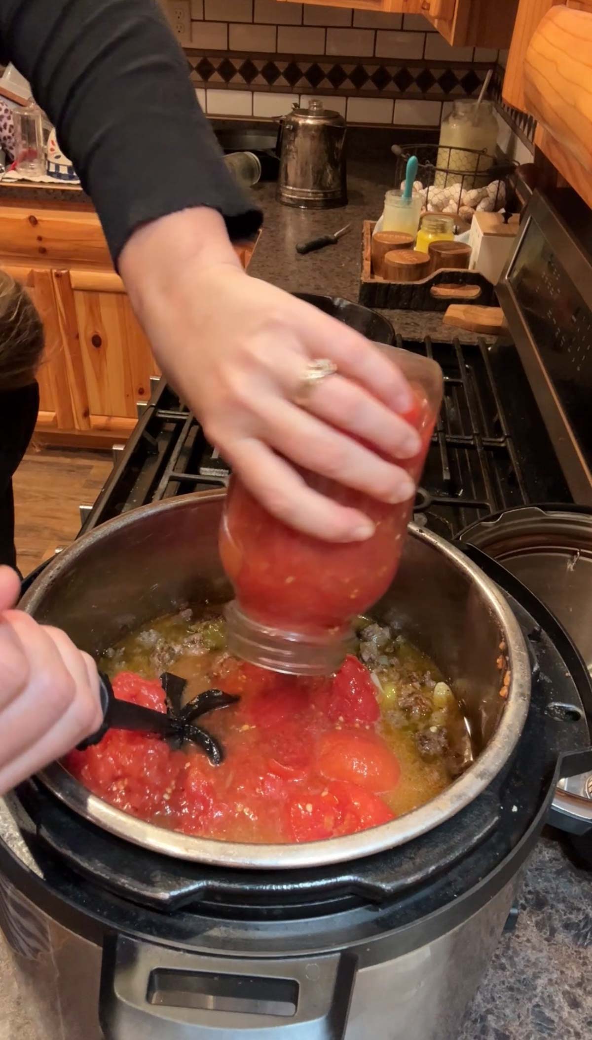 adding tomatoes to chili