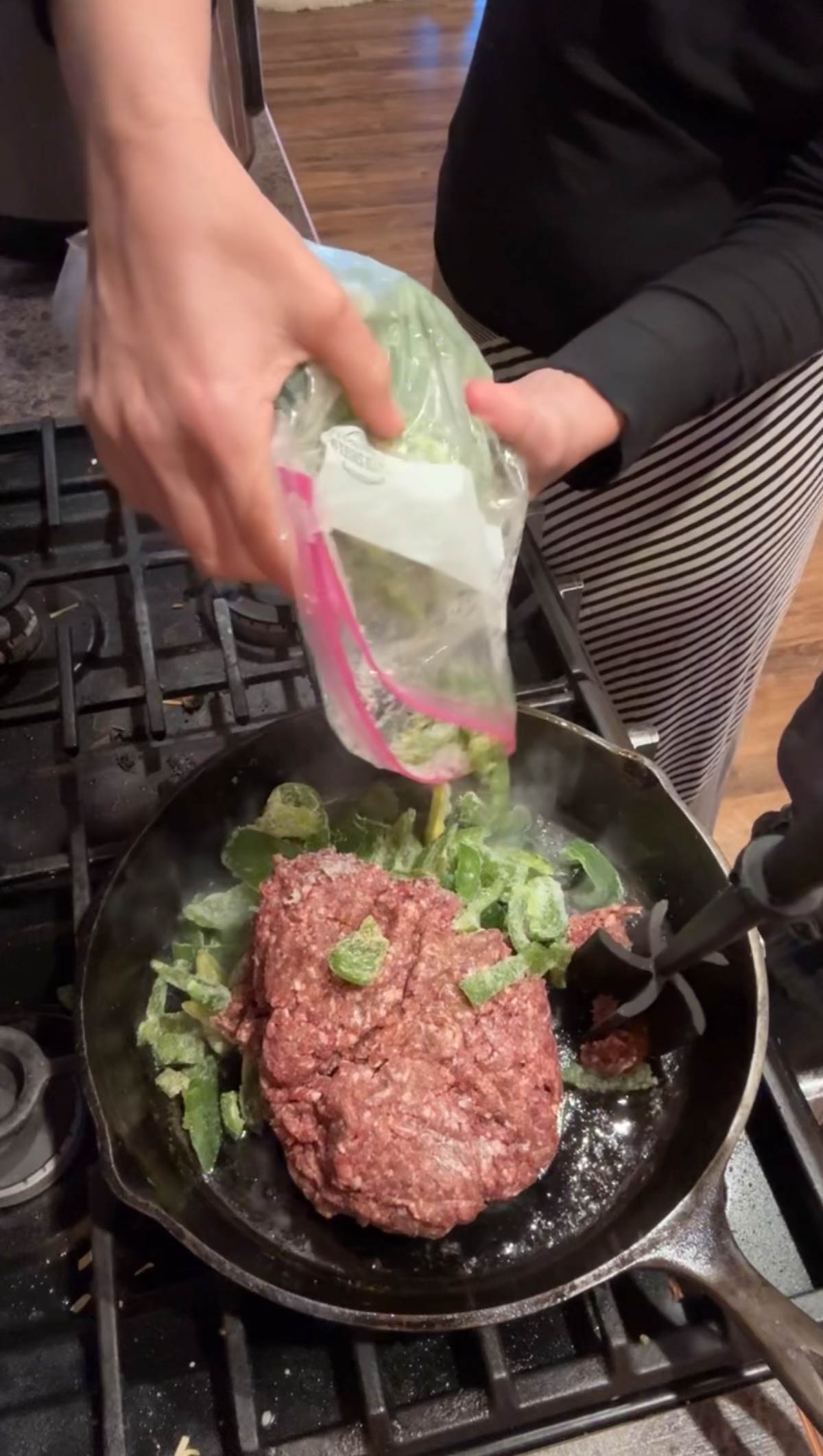 adding peppers to meat