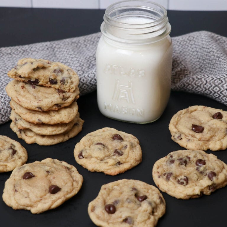 fresh baked chocolate chip cookies with milk square