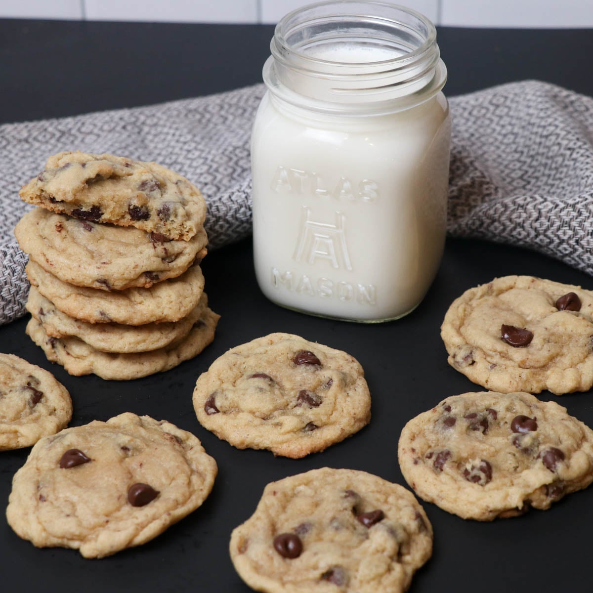 fresh baked chocolate chip cookies with milk square