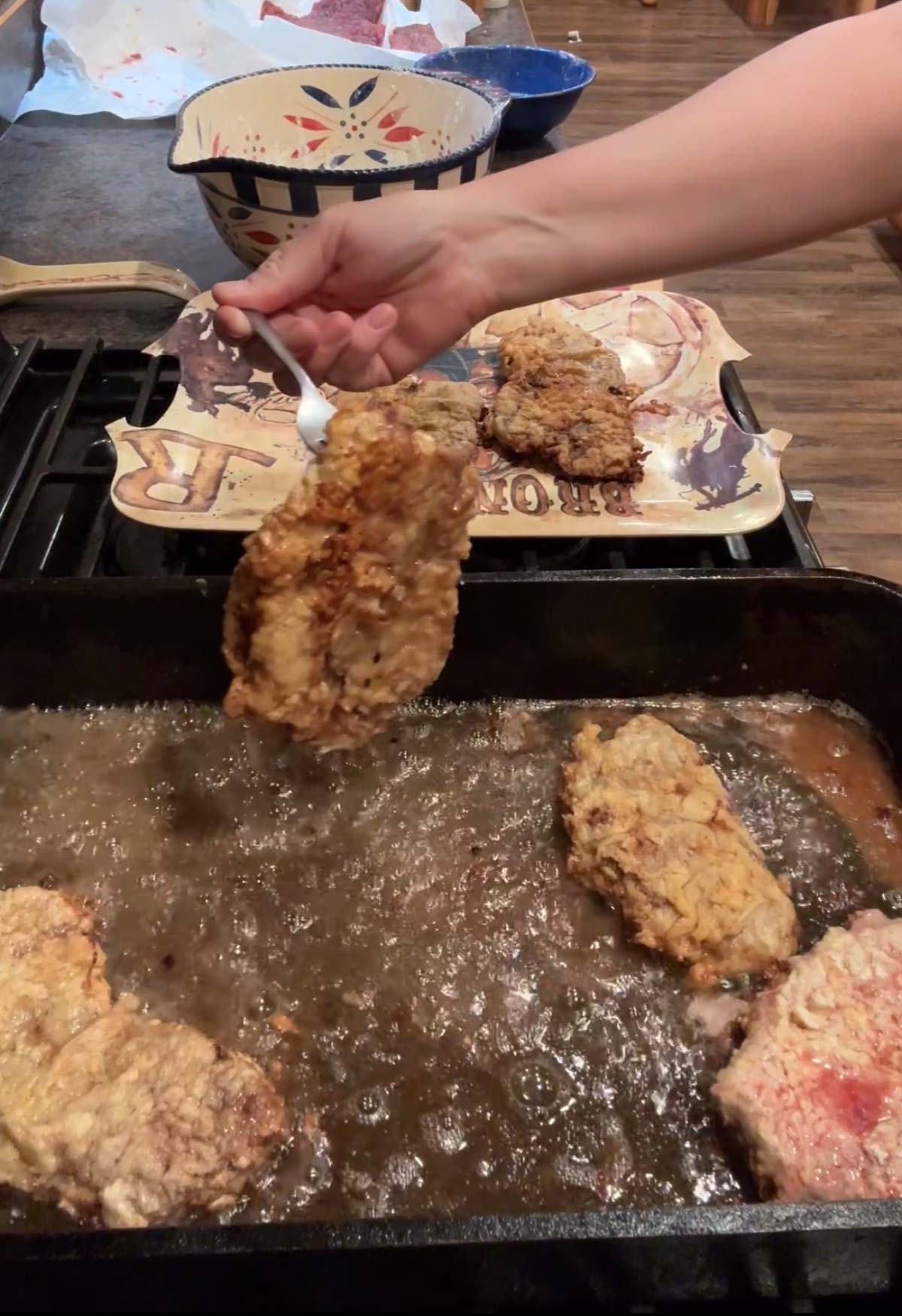 removing chicken fried steak from pan