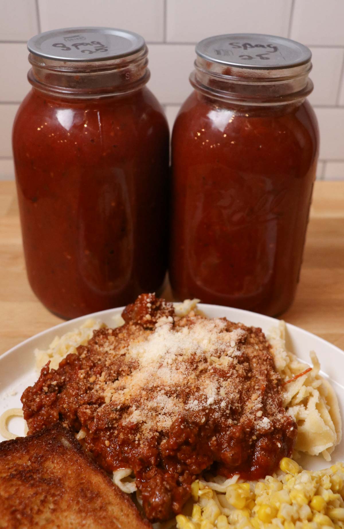 homemade spaghetti with jars of sauce