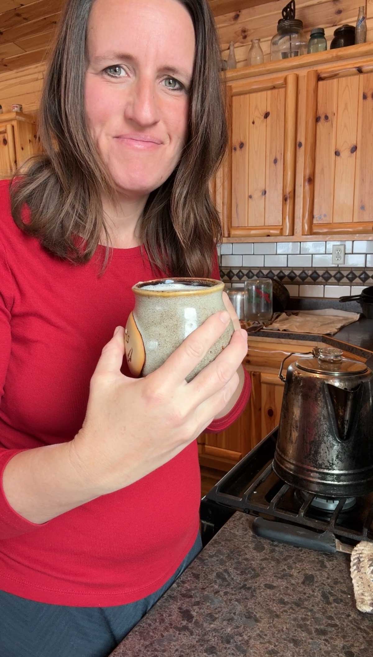 lady smiling with cup of egg yolk coffee