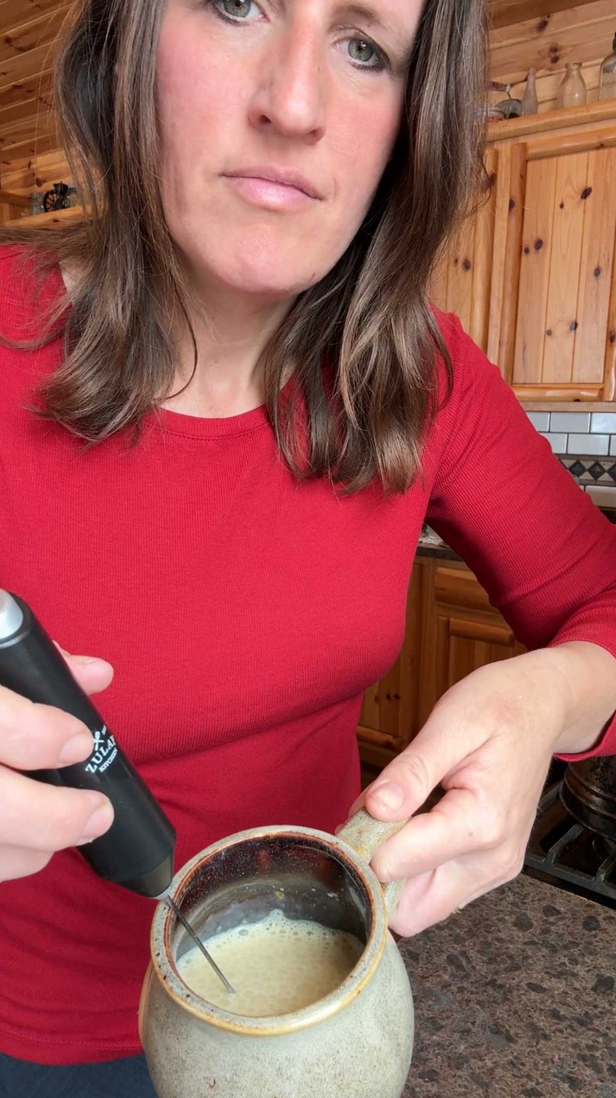 whisking up ingredients in coffee cup for egg yolk coffee