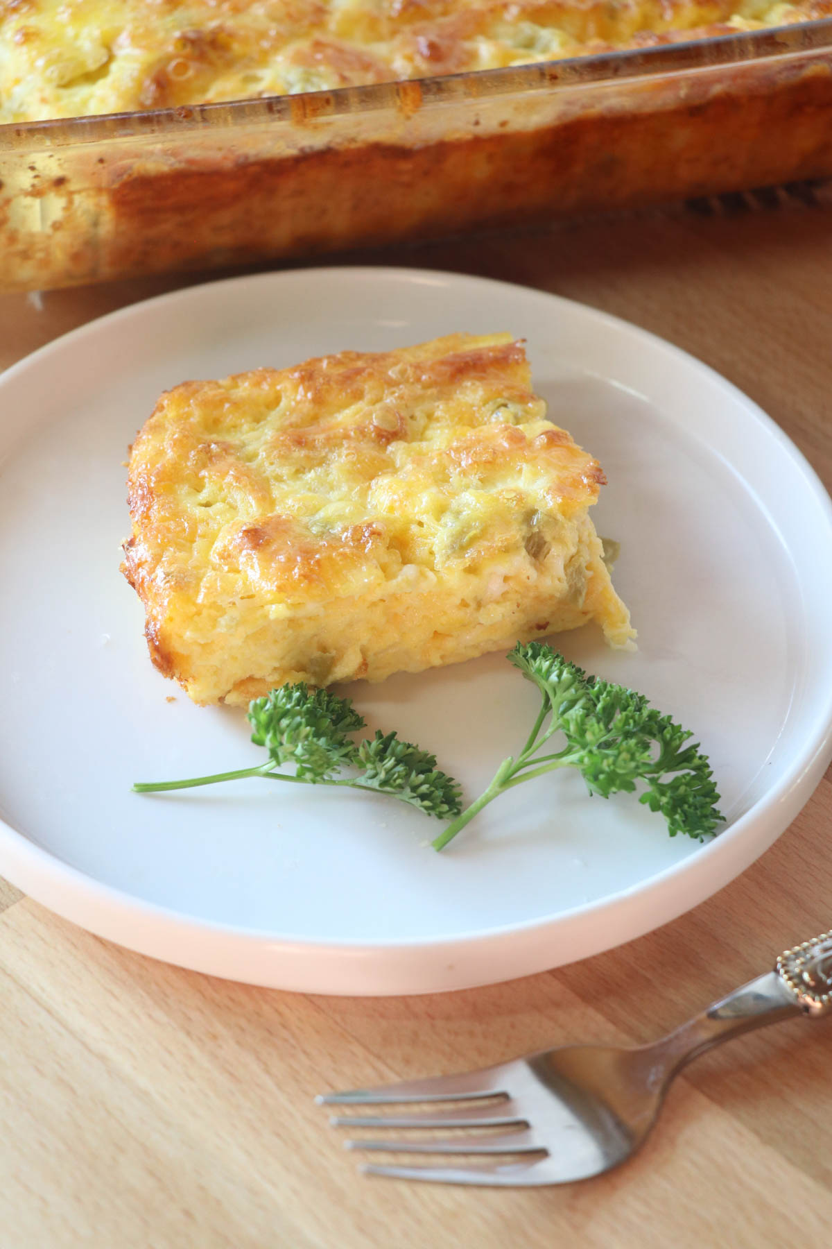 piece of egg casserole with parsley & fork