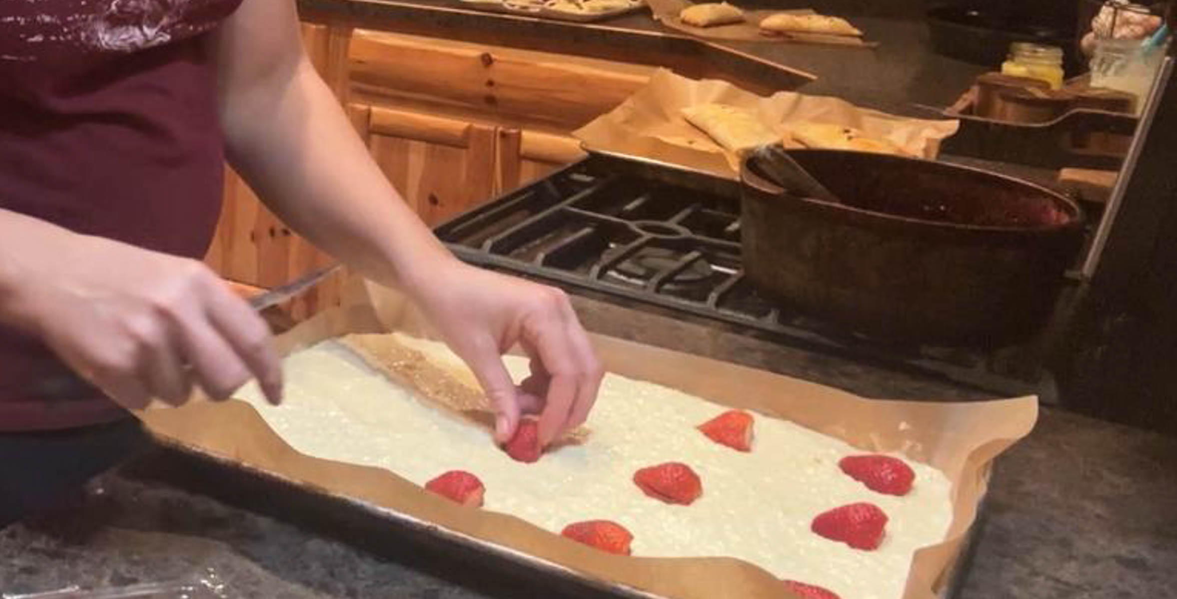 putting strawberries in sheetpan pancakes