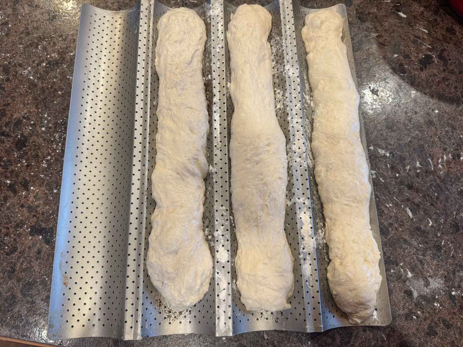 shaped sourdough baguettes in baguette pan