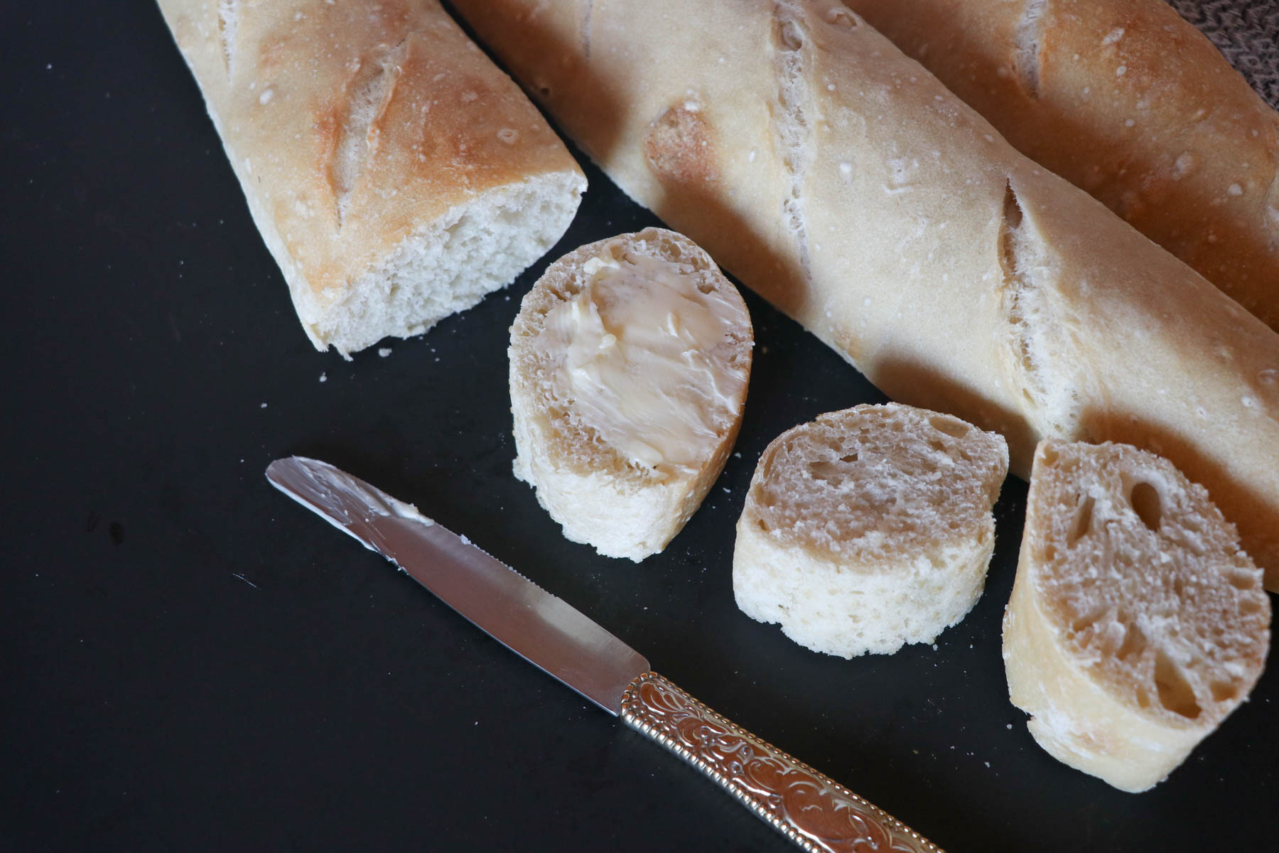 sourdough baguettes sliced with butter