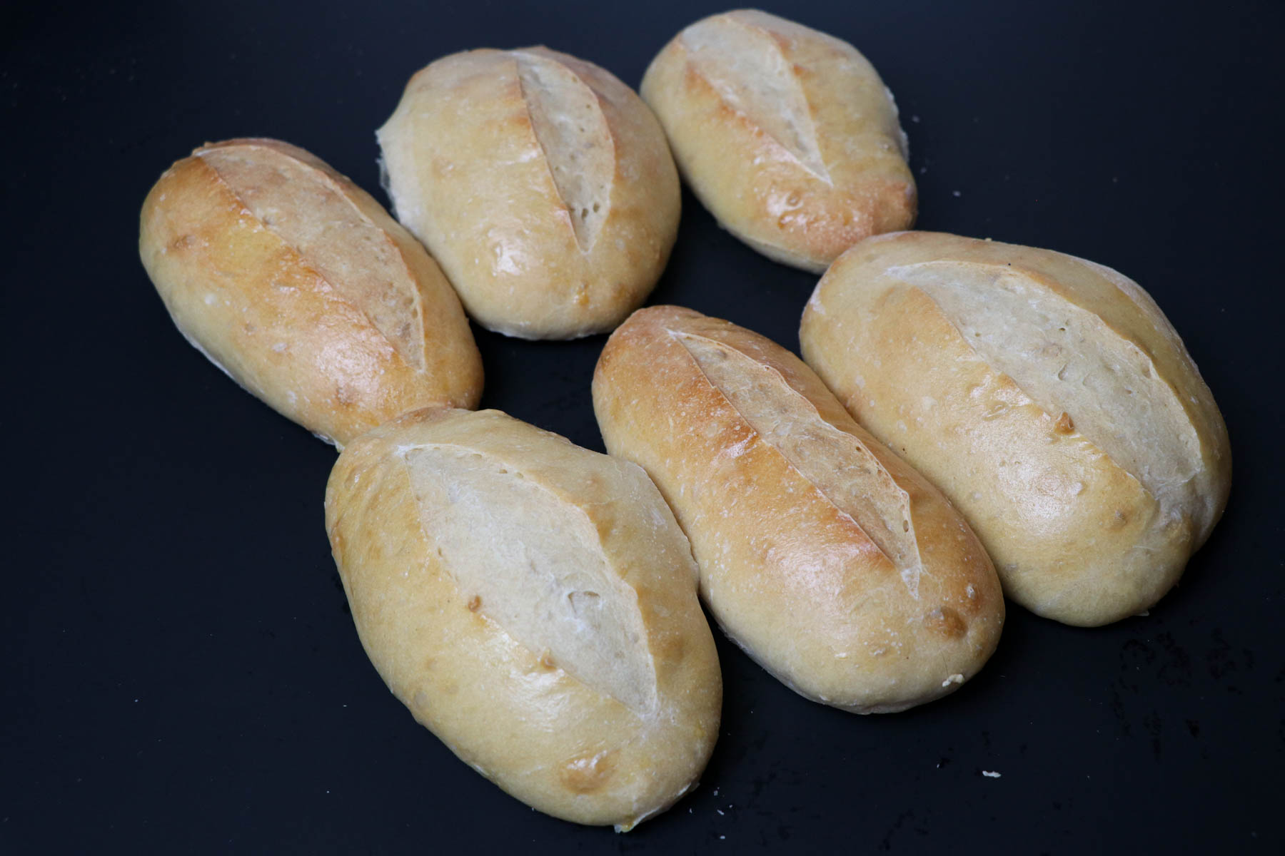 sourdough hoagie rolls on black