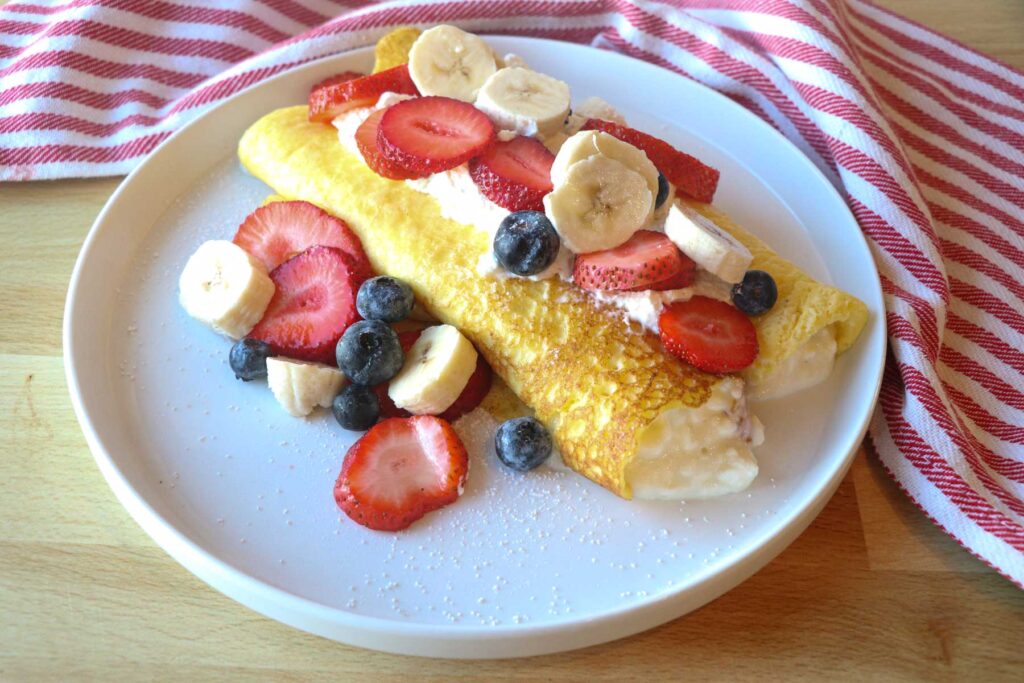 sourdough crepe with berries and whipped cream on plate