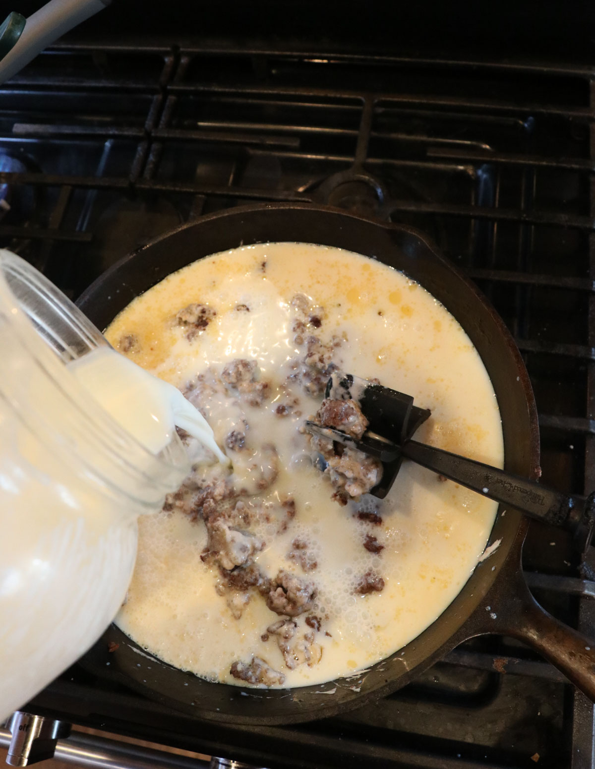 adding milk to skillet to make gravy